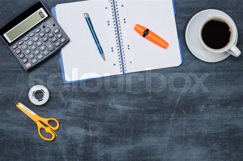 Business desk in office top view. Table with calculator, coffee, notepad, and office supplies. Copy space website banner concept, stock photo