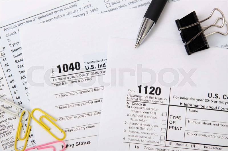 US tax form 1040, 1120 on desk in office, stock photo