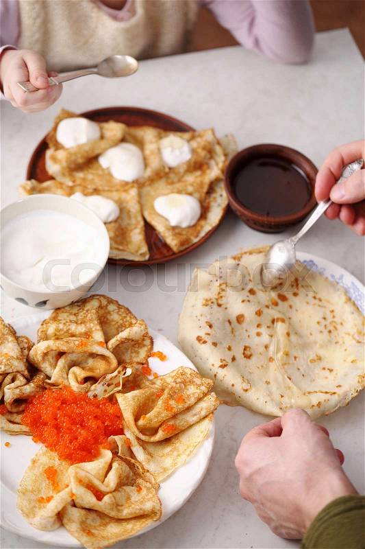 Homemade pancakes with various fillings. people eat pancakes, hands close-up. snack for Shrovetide, stock photo