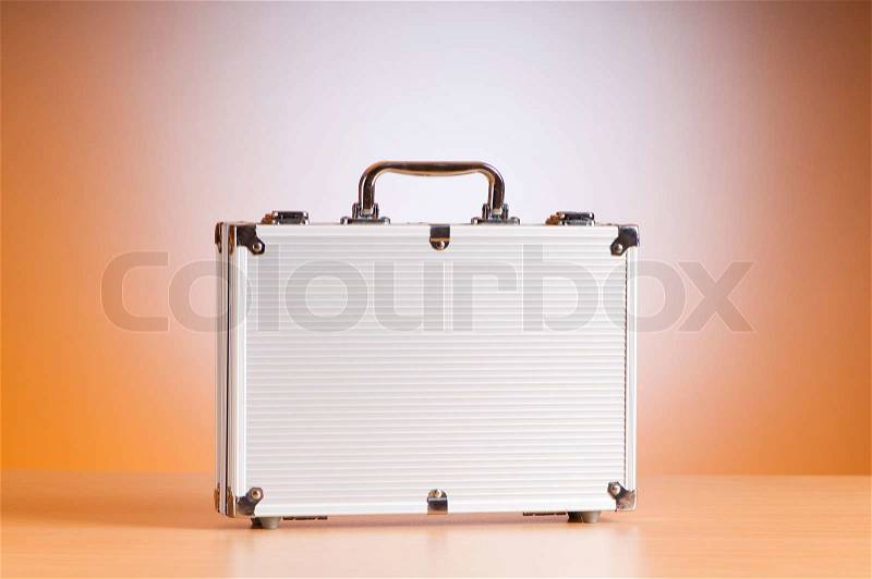 Metal case on the table against background, stock photo