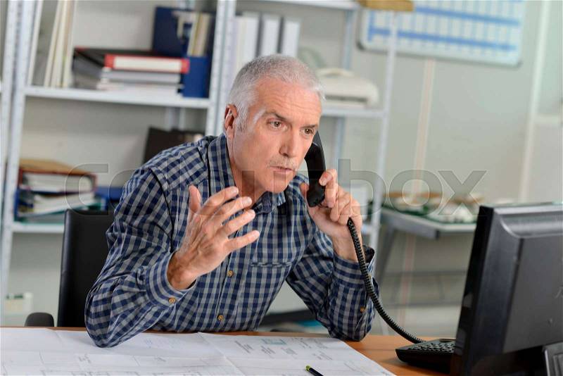 Stressed office worker in the phone, stock photo