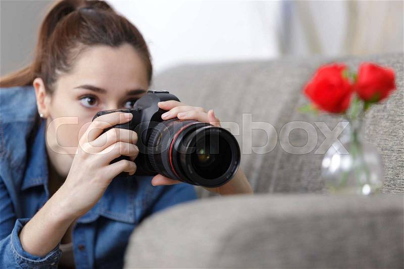 Portrait of a beautiful girl with a camera taking photos, stock photo