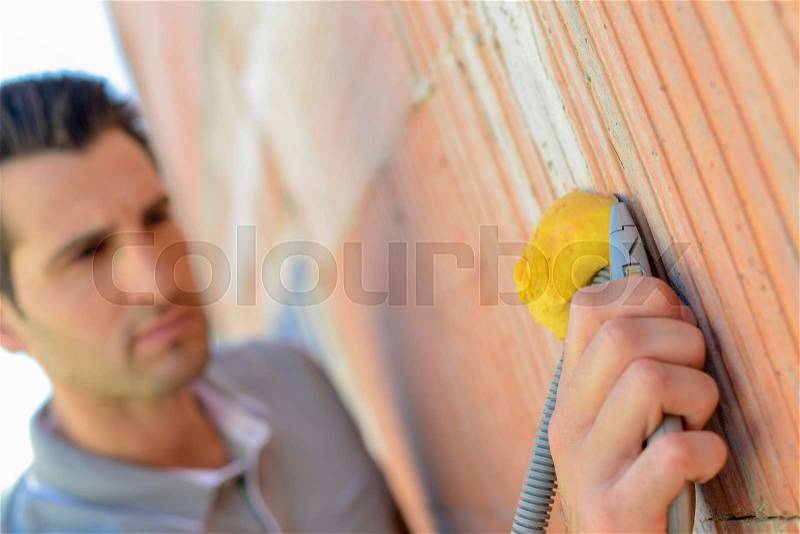 Electrician wiring a house, stock photo