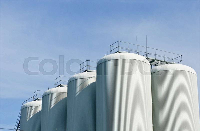 Brewery tanks blue sky big containers beer production industry, stock photo