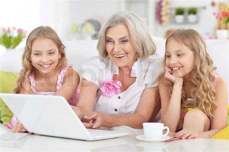 Grandmother and her granddaughters spending time together, stock photo