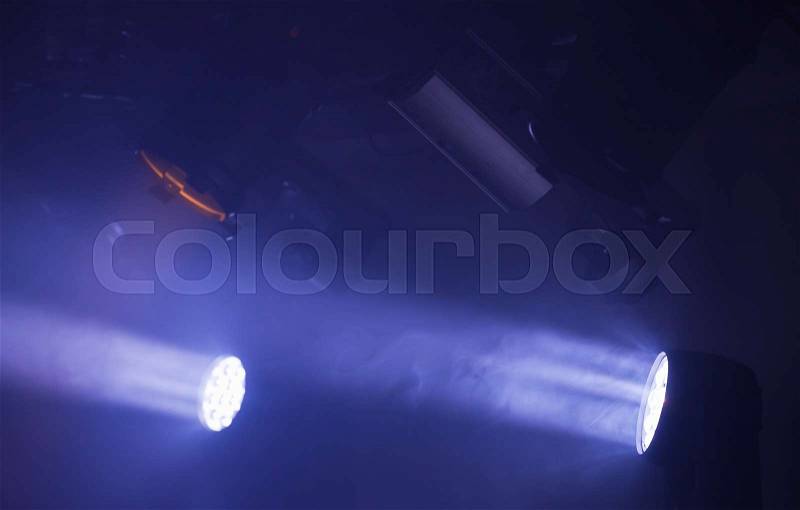 Colorful spot lights with strong beams and smike in the dark, stage illumination background photo, stock photo