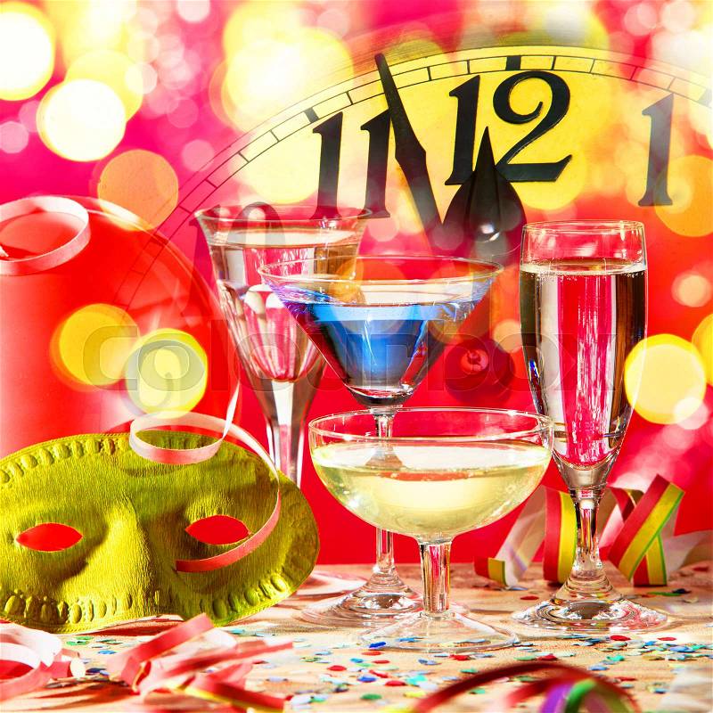 New year clock with wine glasses and confetti, stock photo
