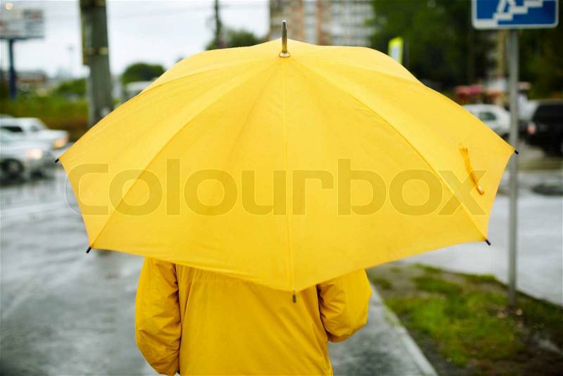 Man with yellow umbrella ,selective focus, stock photo