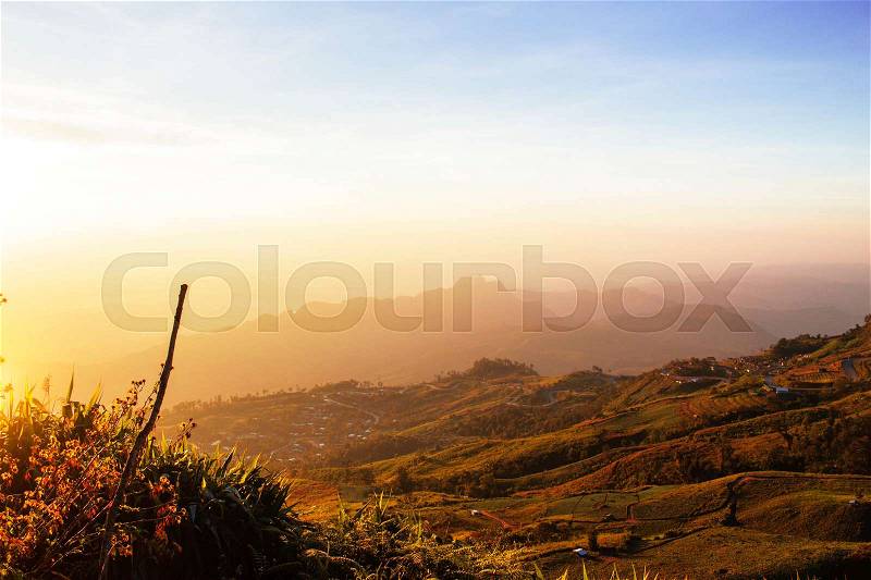 The morning sun on mountains with the hazy sky, stock photo