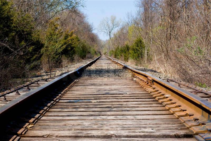 Railroad tracks going off into the distance ahead, stock photo