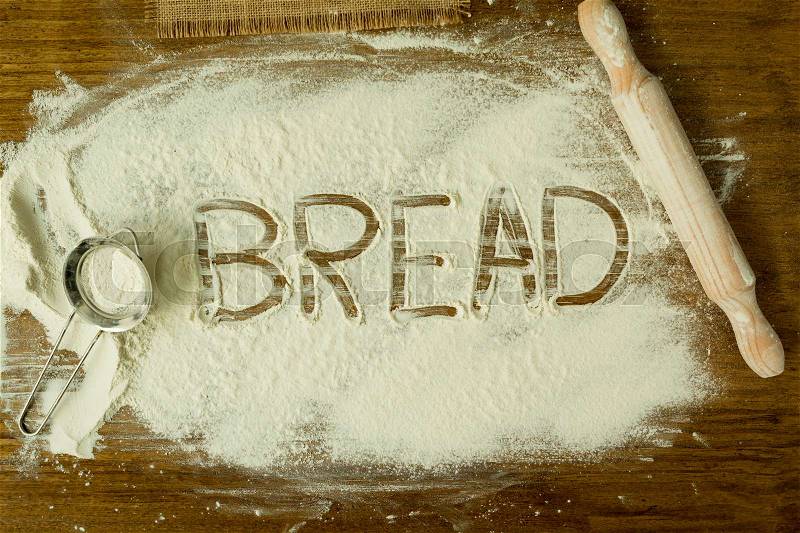 Flour on the table with writted word BREAD, stock photo
