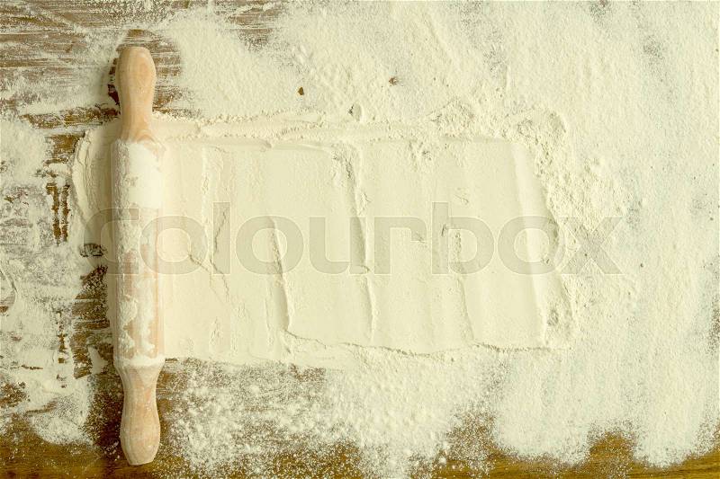 Sifted flour and rolling pin on the table. Kitchen background, stock photo