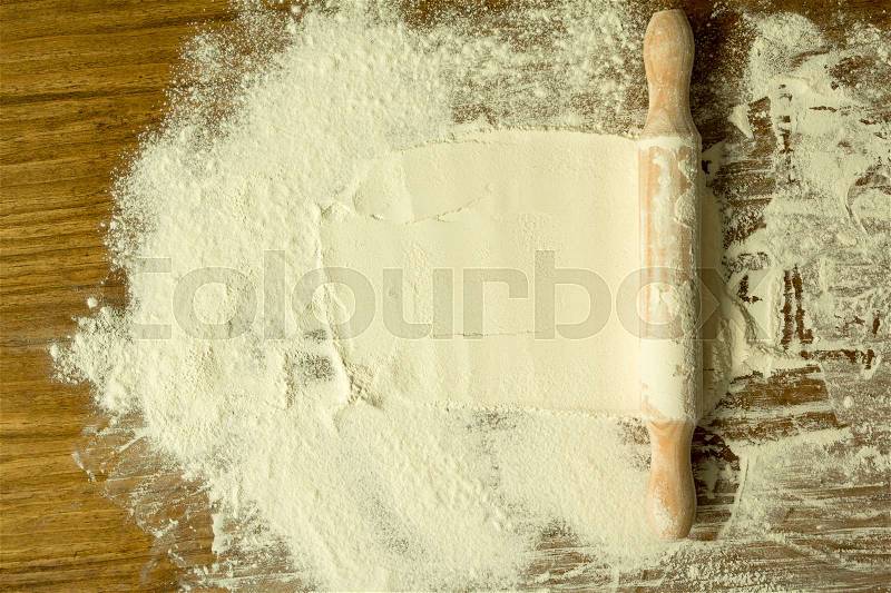 Sifted flour and rolling pin on the table. Kitchen background, stock photo