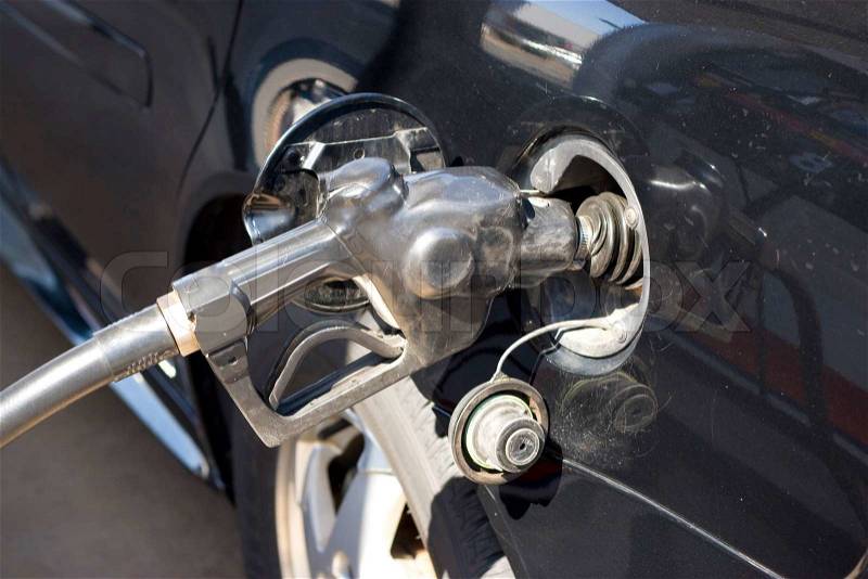 At the gas pump - filling up the tank, stock photo