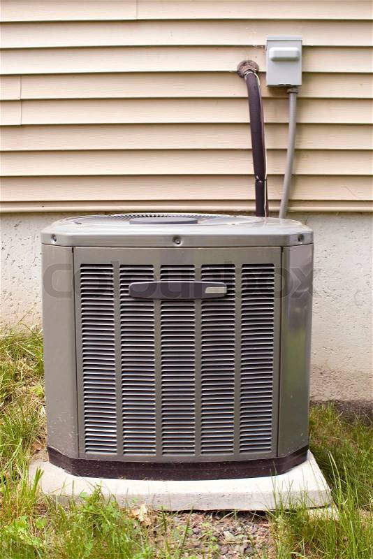A residential central air conditioning unit sitting outside, stock photo
