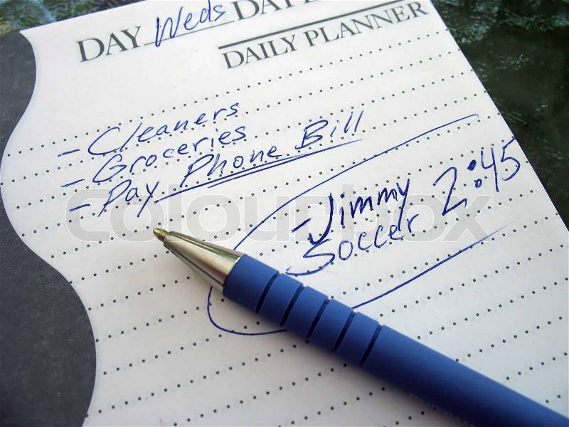 A very busy schedule - written out on a daily planner, stock photo