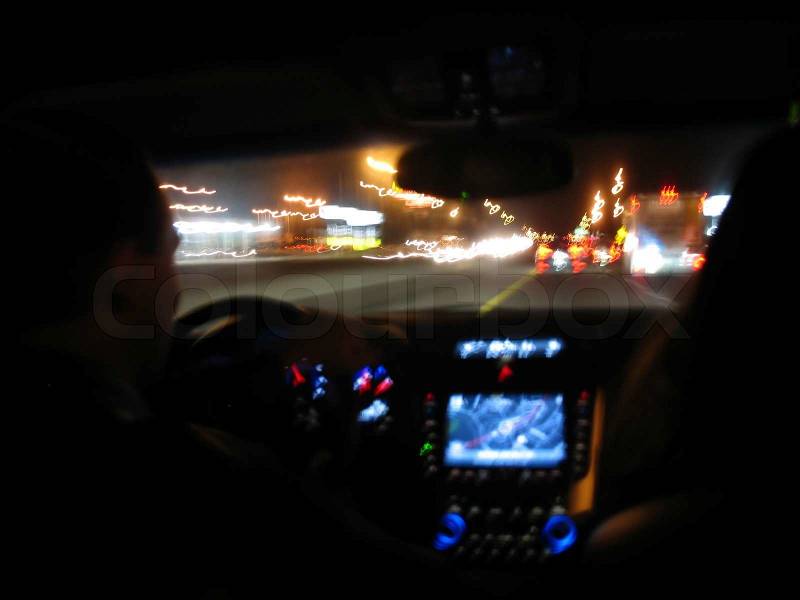Driving at night in a modern luxury vehicle, stock photo