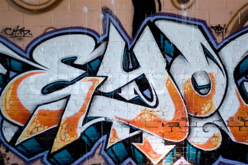 Colorful graffiti spray painted on a brick wall Makes a great background or backdrop, stock photo