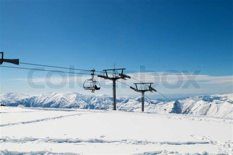 Ski lift chairs on bright winter day, stock photo