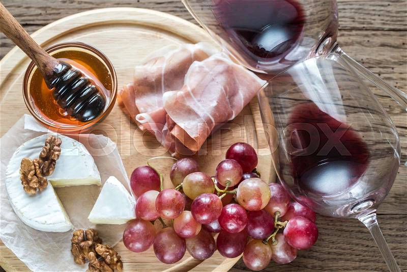 Camembert cheese with glasses of red wine, stock photo