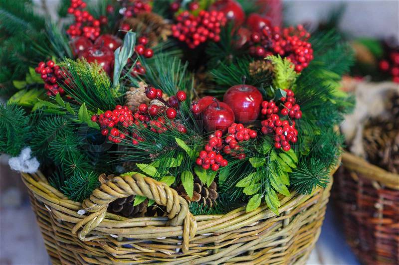 Christmas Decor basket with fir branches and red apples, stock photo