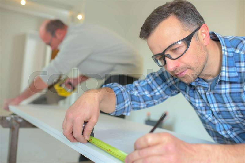 Using a tape measure to be sure, stock photo