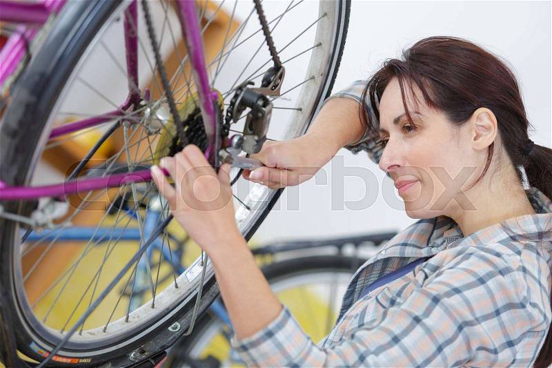 Woman changing the tire, stock photo