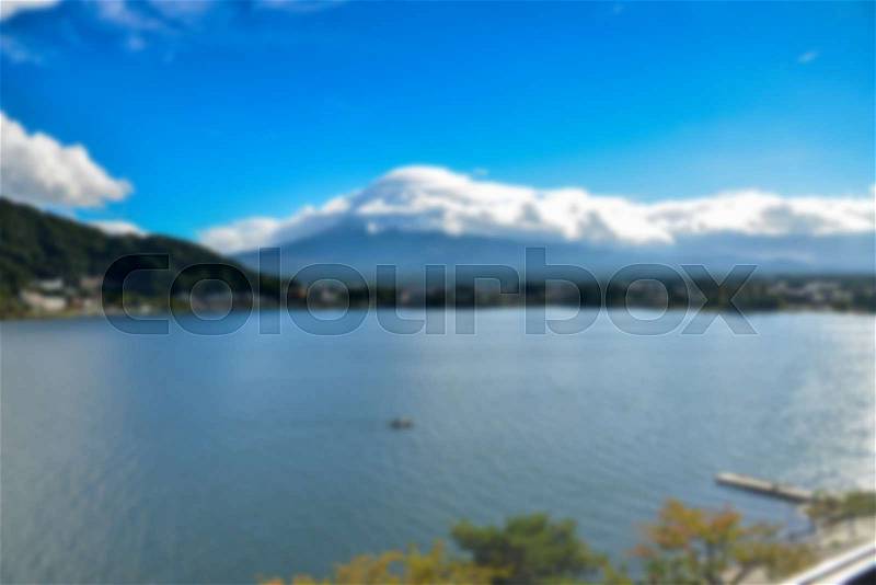 Blurry background Landscape at kawaguchiko lake of Japan with big cloud covered Fuji Mountain, stock photo