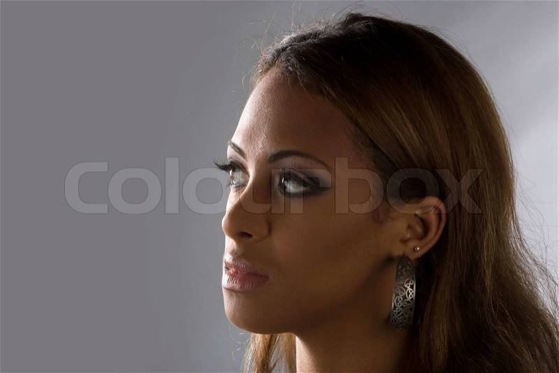 An attractive young woman pondering something very serious, stock photo