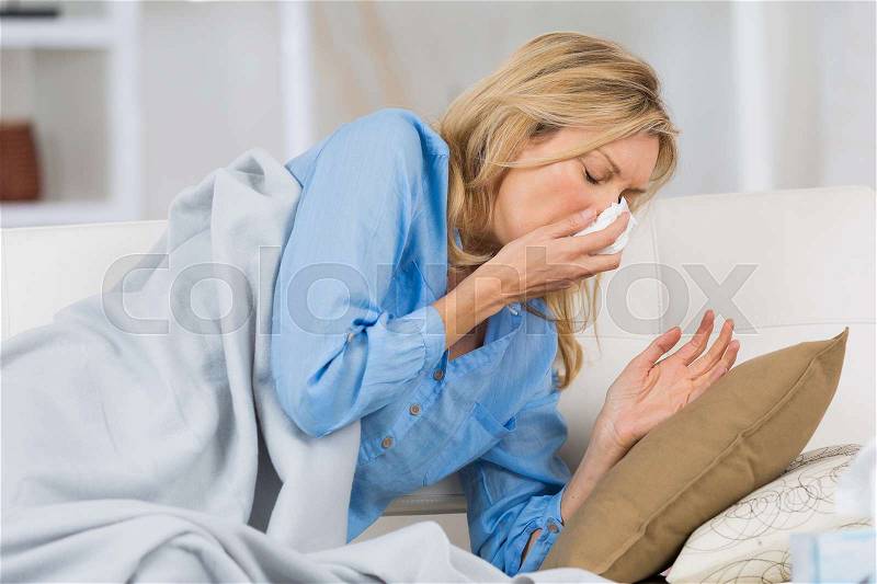 Sick woman sneeze, stock photo