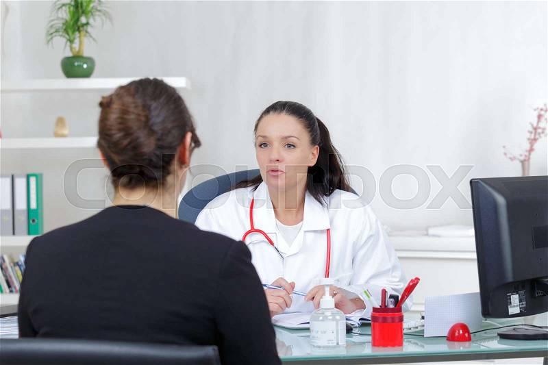 Female doctor having positive news for her patient, stock photo