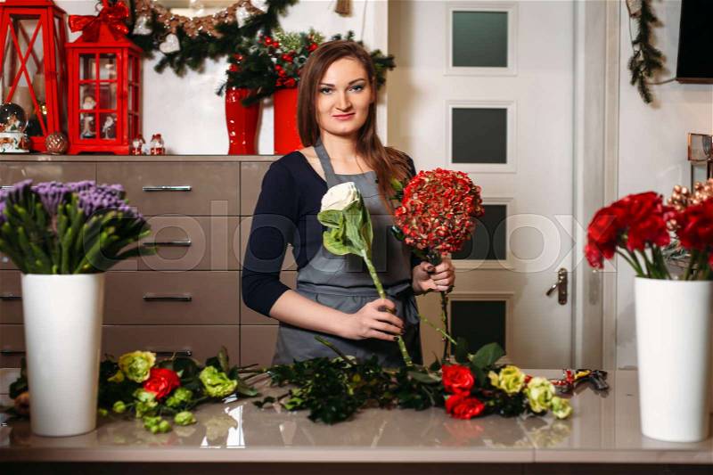 Female florist create beautiful bouquet in flower shop, stock photo