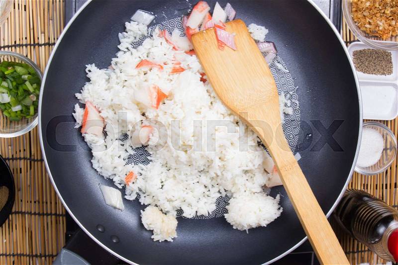 Chef cooking rice in pan / cooking fired rice concept, stock photo
