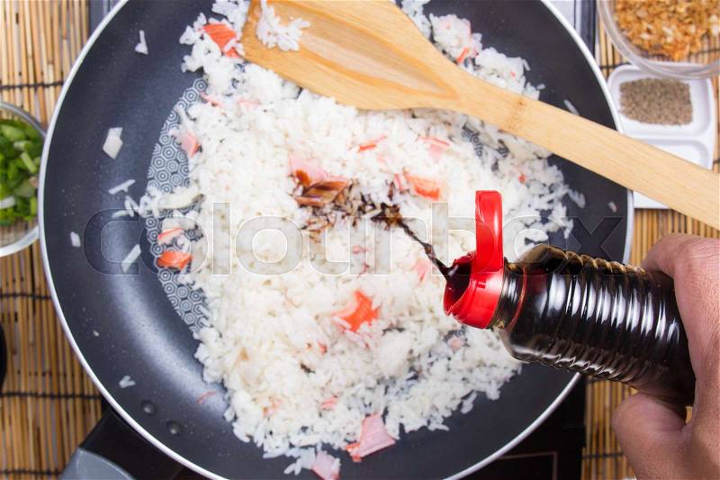 Chef putting soy sauce for cooking rice / cooking fired rice concept, stock photo