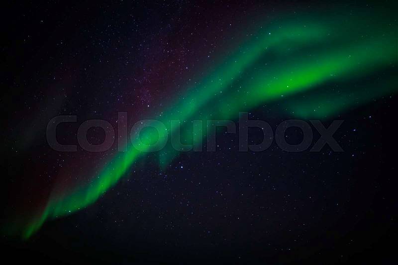 Green northern lights and a starlight sky over Nuuk city, Greenland, stock photo