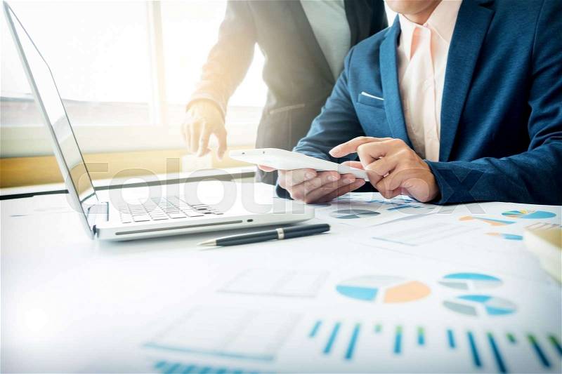 Business adviser analyzing financial figures denoting the progress in the work of the company, stock photo