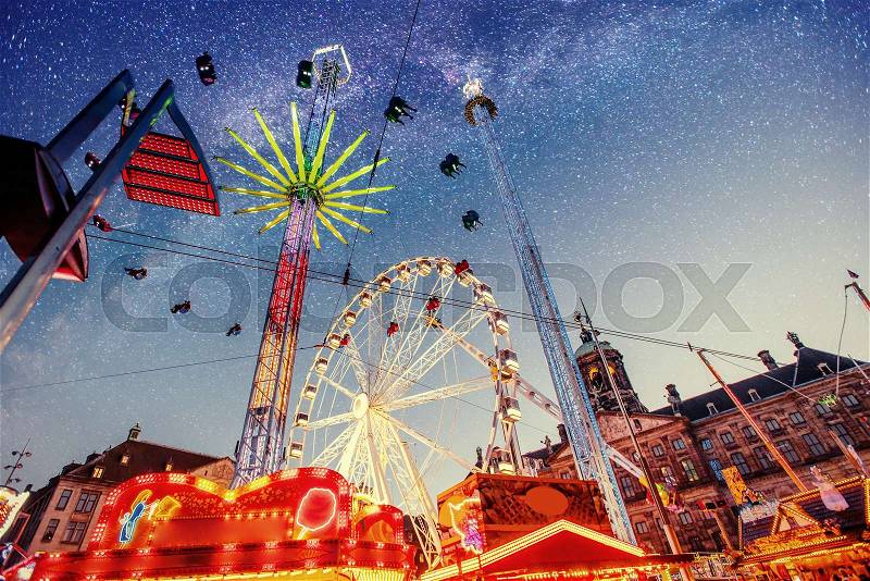 Fantastic starry sky on amusement park attractions, stock photo