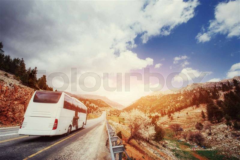 Bus moving on asphalt road, stock photo