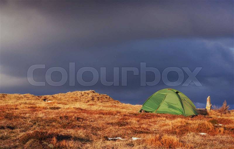 Tourist tent in the mountains in spring, stock photo