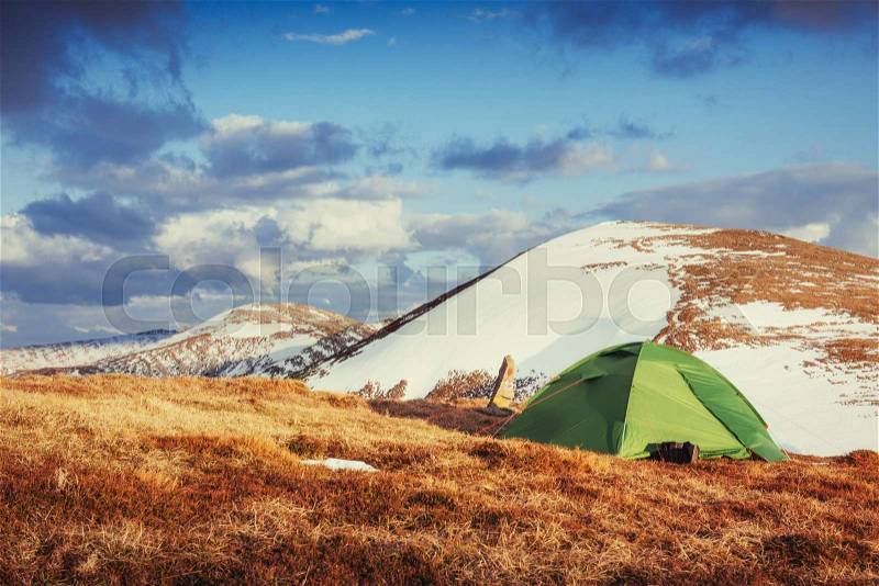 Tourist tent in the mountains in spring, stock photo