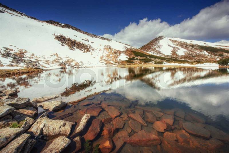 Lake between mountains. Spring landscape. Carpathians. Ukraine. Europe, stock photo