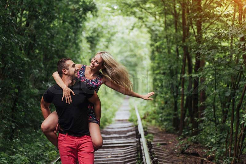 Loving couple in love tunnel iron road, stock photo