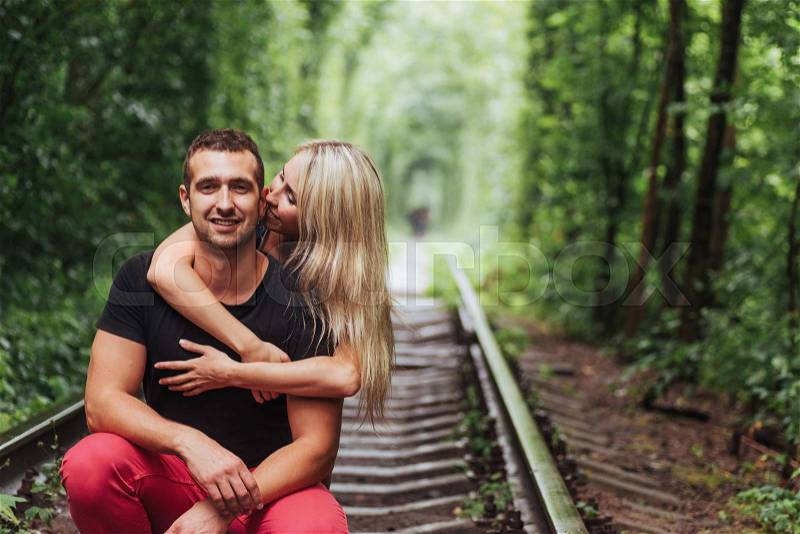Loving couple in love tunnel iron road, stock photo