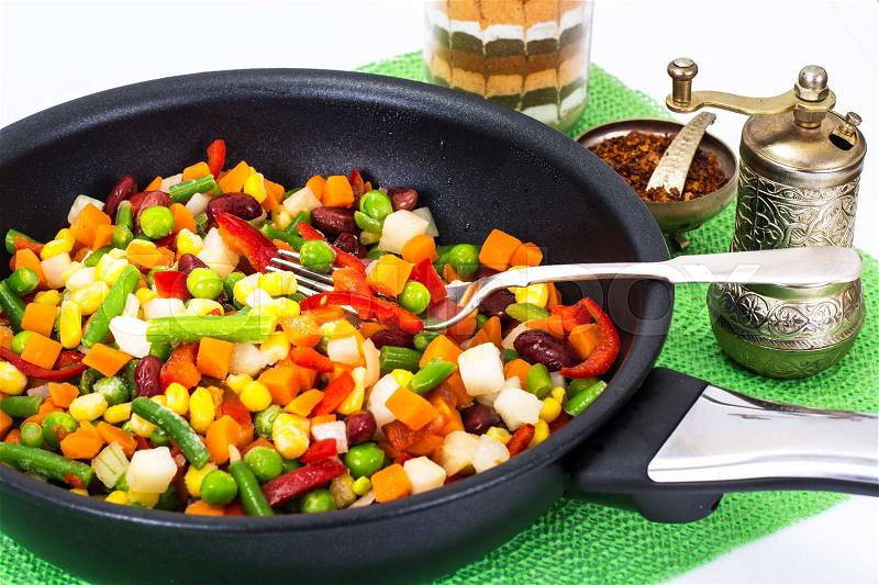 Mexican mixture of vegetables, cooked in a frying pan. Studio Photo, stock photo
