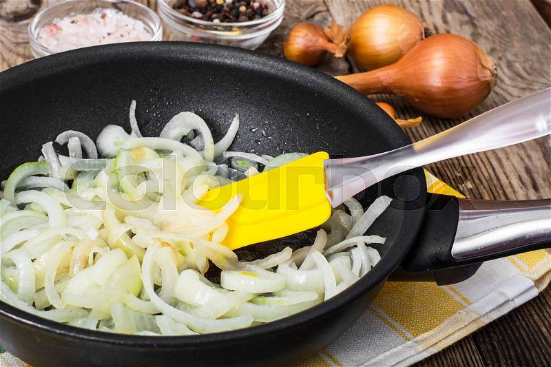 Browned onion in oil in a frying pan. Studio Photo, stock photo