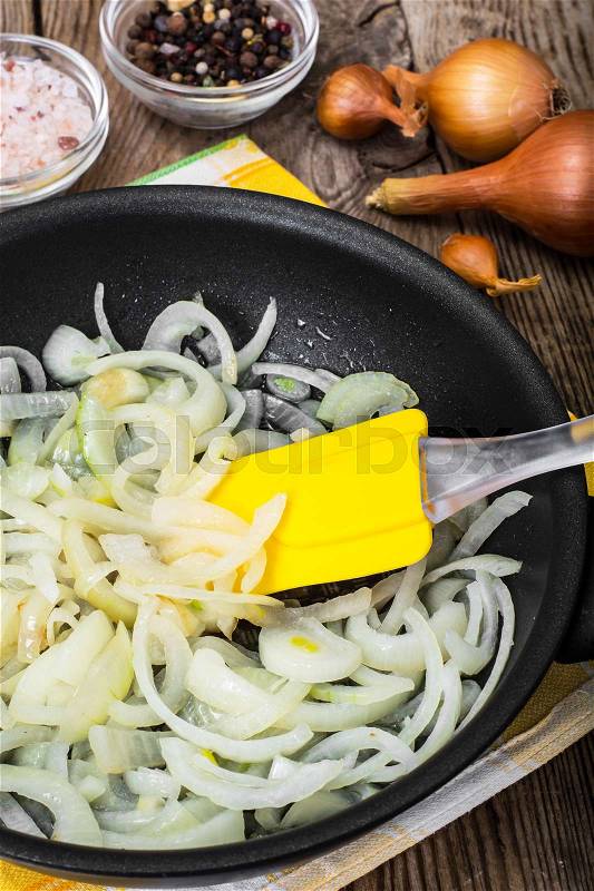 Browned onion in oil in a frying pan. Studio Photo, stock photo