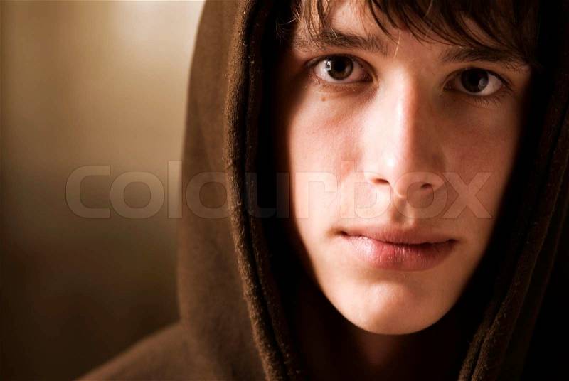 Young adult with hood, special toned photo f/x, focus point on eye, stock photo