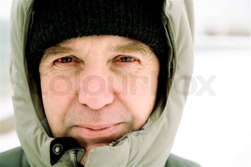 Man in jacket with hood, focus point on eye, stock photo