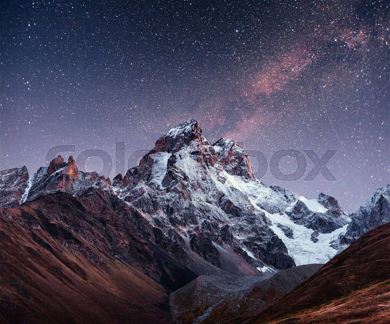 Fantastic starry sky. Autumn landscape and snow-capped peaks. Main Caucasian Ridge. Mountain View from Mount Ushba Meyer, Georgia. Europe, stock photo