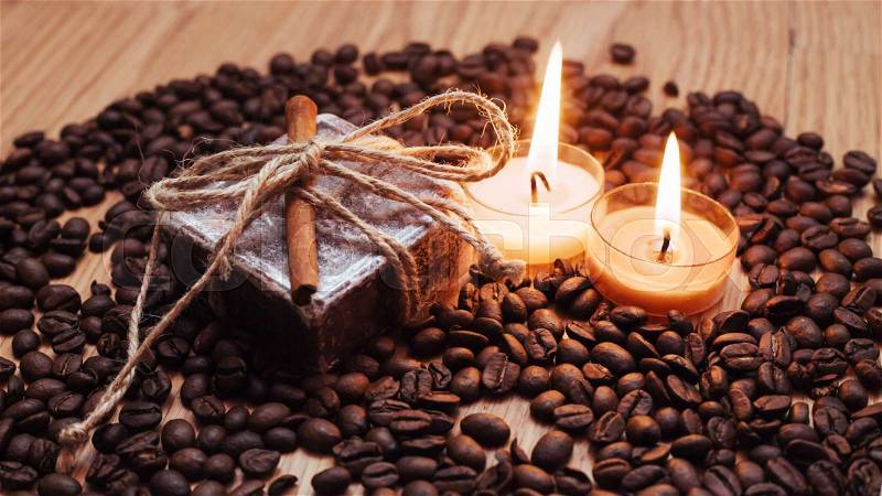 Burning aromatic coffee candle and coffee beans, close-up, stock photo